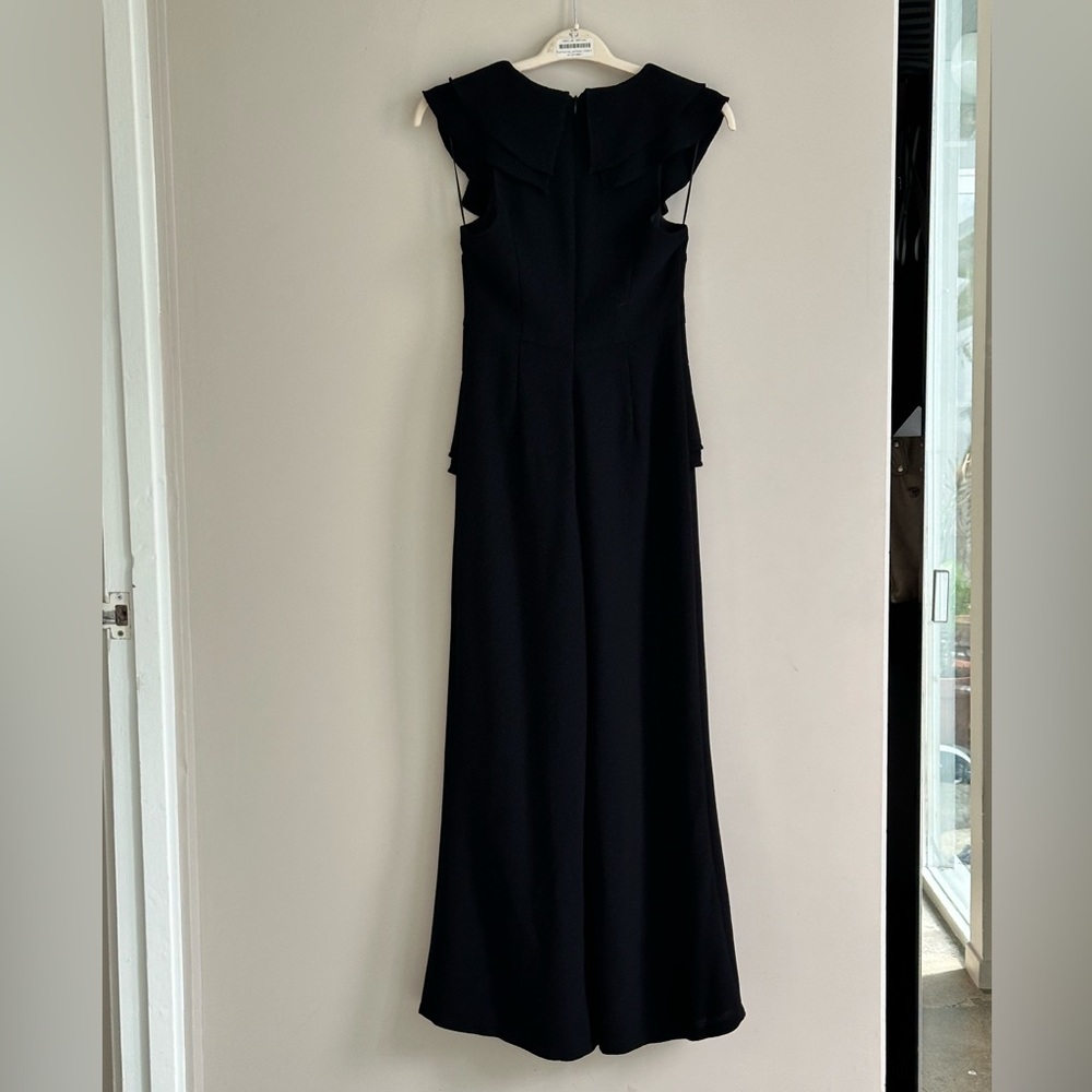 Black sleeveless jumpsuit with frills from C/MEO Collective